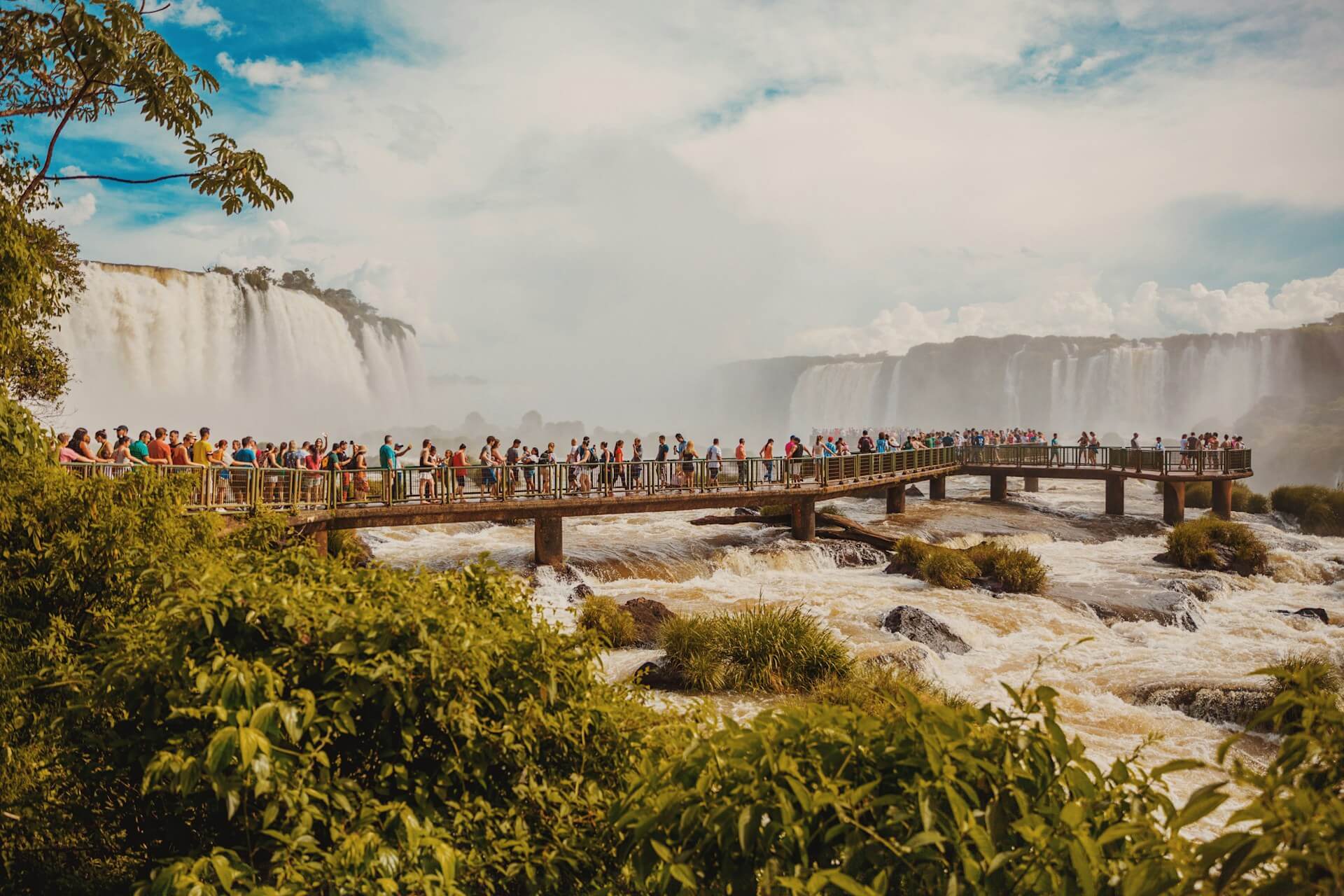 People gathered at a waterfall, symbolizing humanity's shared connection to nature and each other